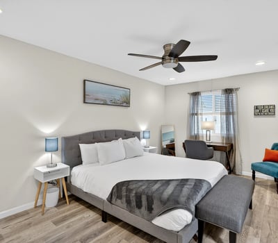 Bright and airy primary bedroom with modern flooring, workspace, and natural light designed for relaxation in this Scottsdale residence.