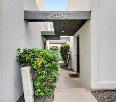 Quiet Scottsdale entry courtyard with covered patio and desert landscaping provides a peaceful, low-maintenance outdoor space.