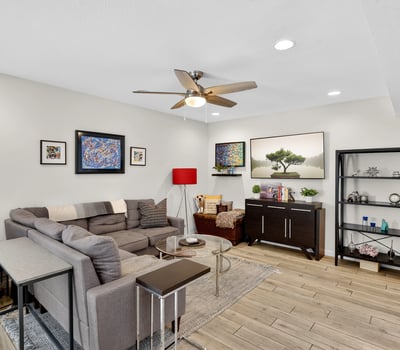 Spacious Scottsdale living room with modern finishes, recessed lighting, and open flow into the dining area perfect for relaxing or entertaining.