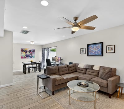 Light-filled Scottsdale living and dining space with open layout, modern finishes, and ceiling fan perfect for entertaining and daily living.