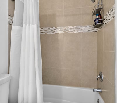 Scottsdale bathroom showcasing tiled shower walls, accent detailing, and functional layout for comfortable daily use.