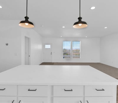 Spacious great room connected to the kitchen, creating a seamless flow throughout the home's main living areas. Recessed lighting, large windows, and an airy layout make this space ideal for family gatherings and entertaining.