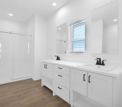 Beautiful primary bath featuring dual sinks, contemporary finishes, glass shower enclosure, and ample storage. Designed with comfort and functionality in mind, this space serves as a relaxing daily retreat.