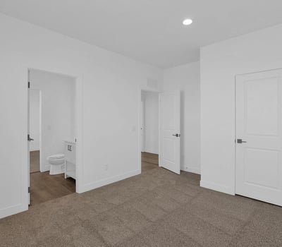 Well-sized bedroom featuring plush carpet, recessed lighting, and a clean modern design. A versatile space that can easily accommodate a variety of living arrangements and personal needs.