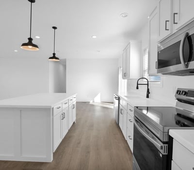 Expansive great room designed for modern living, offering generous square footage and seamless connection to the kitchen. The open-concept floor plan creates an inviting environment for entertaining and daily activities.