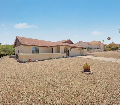 The generous lot and desert landscaping provide a peaceful setting with attractive neighborhood and mountain views. Enjoy the benefits of a low-maintenance property designed for comfortable Arizona living.