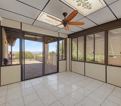 Large windows and tile flooring define this bright Arizona room, creating a comfortable extension of the home's living space. Perfect for entertaining, reading, or enjoying views of the surrounding landscape.