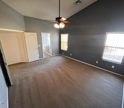Comfortable primary bedroom featuring large windows, elevated ceilings, and generous square footage. A peaceful retreat designed to provide comfort and privacy.