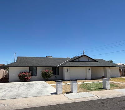 Well-maintained Glendale residence featuring a wide driveway, mature landscaping, and attractive ranch-style architecture. Fresh exterior updates create outstanding curb appeal.
