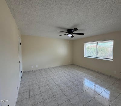 Well-appointed bedroom with generous dimensions, tile flooring, and natural light. Perfect for guests, family members, or creating a productive work-from-home environment.