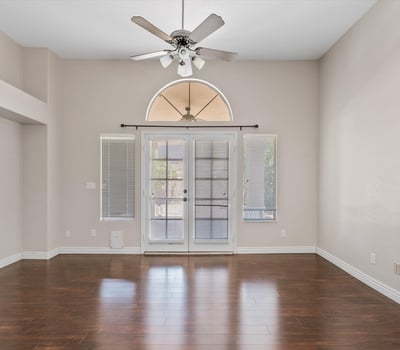 Relax in the generous main-floor primary suite featuring wood flooring, vaulted ceilings, and French doors opening to the backyard. This peaceful retreat combines comfort, privacy, and direct outdoor access.
