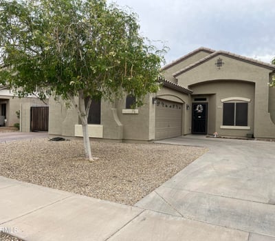Generous backyard offers a spacious paver patio, grassy area, raised planter beds, and privacy walls, providing endless possibilities for entertaining or outdoor enjoyment.