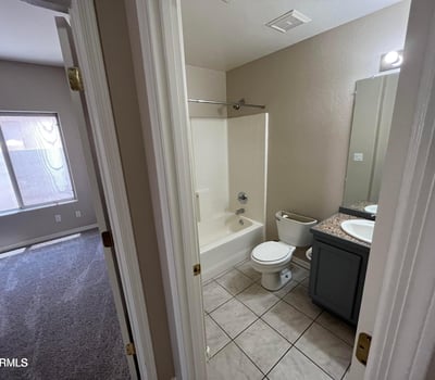 Clean and functional, this full bathroom offers a tub and shower combination, updated vanity, tile flooring, and a practical layout for family and guests.