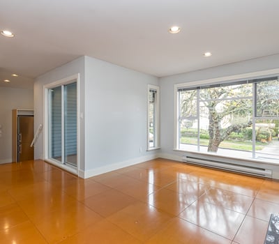 Bright, open living space featuring large windows and easy access to outdoor views and natural light.