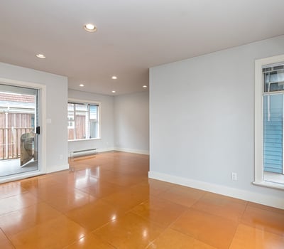 Spacious open-concept living area with natural light and access to a private outdoor balcony.