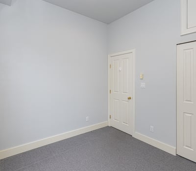 Bright and spacious room with neutral tones, offering ample storage and potential for customization.