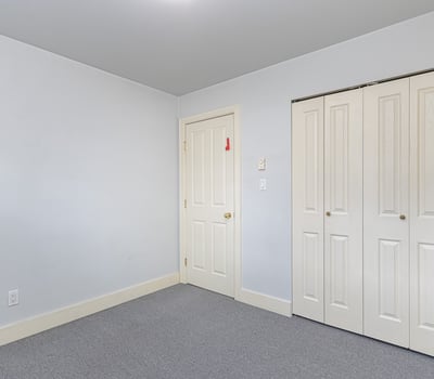 Bright, versatile room with ample closet storage and neutral tones, perfect for personalizing to your taste.