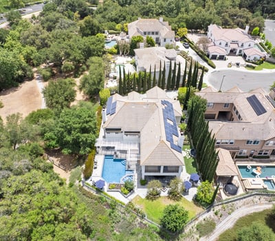 Stunning aerial view showcasing a spacious property with luxurious outdoor amenities and lush landscaping.