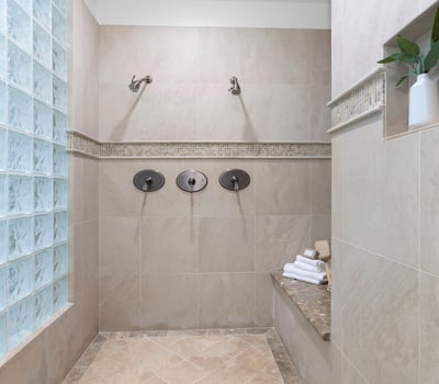 Primary Bathroom-Discover a spacious walk-in shower featuring dual showerheads and modern finishes, perfect for daily relaxation.