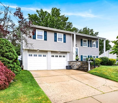Charming bi-level home with lush greenery.