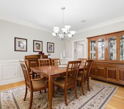 Elegant formal dining room with hardwood floors, detailed wainscoting, crown molding, and room to gather comfortably for holidays, dinner parties, and everyday celebrations.