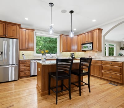 Spacious kitchen featuring custom cabinetry, modern fixtures, and an inviting island perfect for hosting gatherings.