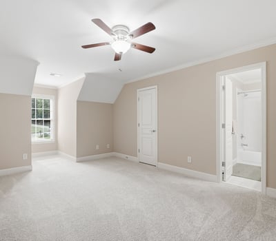 Spacious, multi-functional room featuring plush carpet, natural light, and an en-suite bathroom for convenience.