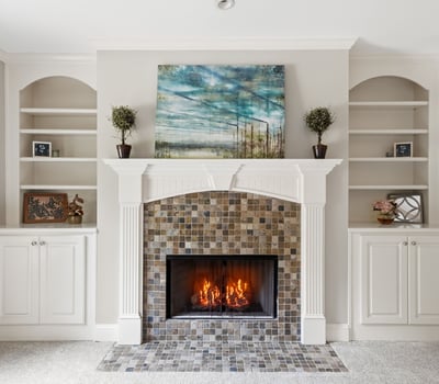 Cozy living room featuring a striking fireplace and built-in shelving for personalized decor.