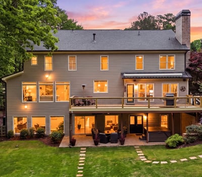 Spacious home with large windows and a welcoming deck, perfect for entertaining and enjoying outdoor views.