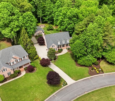 Discover a picturesque neighborhood featuring spacious homes surrounded by lush greenery and beautifully landscaped yards.