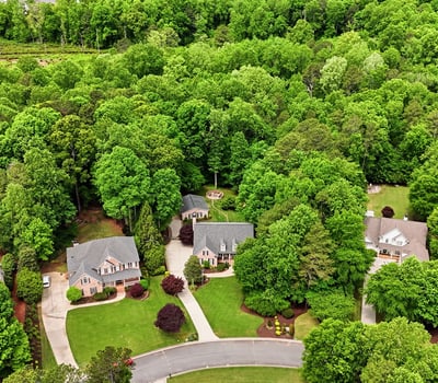 Discover a landscaped community nestled among lush greenery, offering privacy and a peaceful suburban lifestyle.