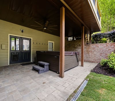 Discover this covered patio featuring a hot tub, perfect for outdoor relaxation and entertaining.