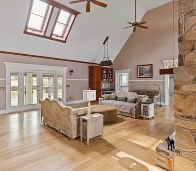Spacious living area with large windows and unique architectural features, perfect for entertaining or relaxing.