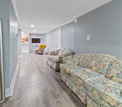 Bright and spacious lower level featuring a cozy seating area and convenient access to entertainment options.