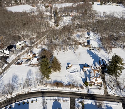 Expansive winter landscape featuring spacious lots and scenic views, perfect for your dream home development.