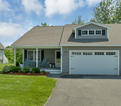This inviting home features an ample front yard, covered porch, and convenient garage space.