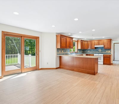 Modern kitchen featuring ample natural light, updated cabinetry, and direct access to an outdoor deck.