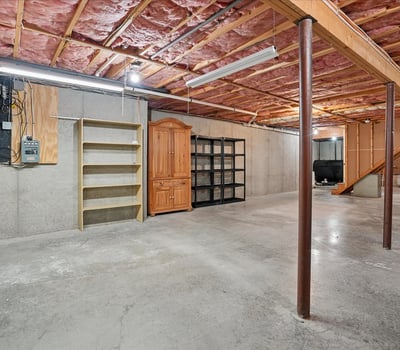 Spacious unfinished basement featuring ample storage options and potential for customization to suit your needs.