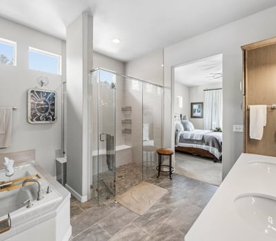 Primary Suite with attached 5 piece bath and walk in closet.