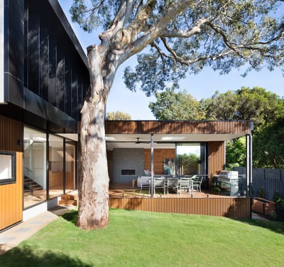 Contemporary home featuring expansive outdoor living space, lush greenery, and stylish architectural design. Perfect for entertaining!
