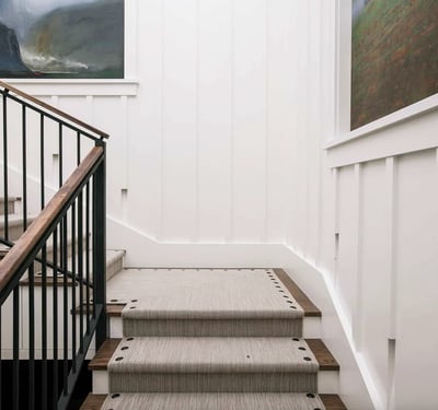 Stylish staircase featuring elegant wood accents and contemporary artwork, perfect for enhancing your home's aesthetic.
