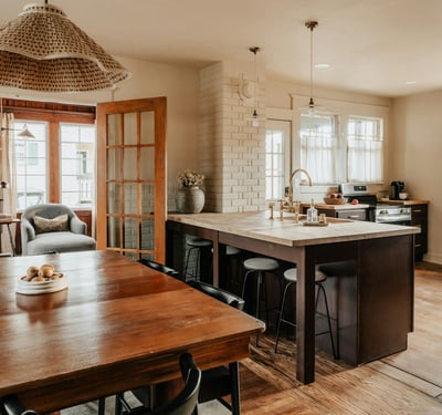 Modern kitchen and dining area with abundant natural light and a welcoming open layout for gatherings.