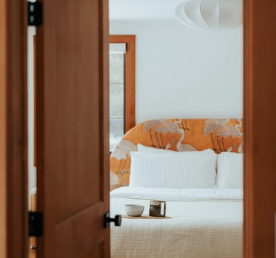 Light-filled bedroom featuring a unique headboard design and a cozy atmosphere, perfect for restful retreats.