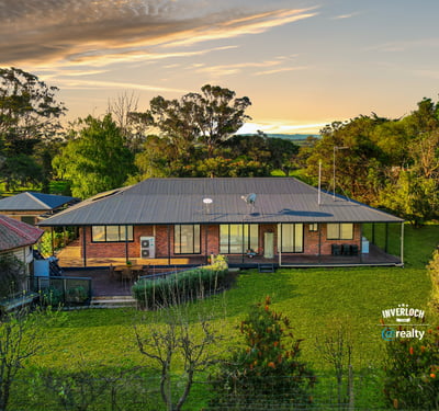 Spacious home set on lush grounds, featuring expansive outdoor areas and stunning views of the landscape.