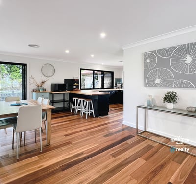 Spacious open-plan living area with modern finishes, large windows, and abundant natural light throughout.