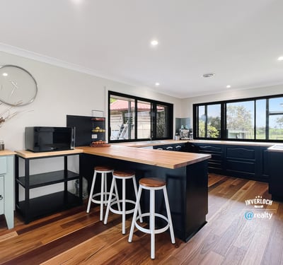 Bright and functional kitchen featuring modern appliances, ample counter space, and scenic views through expansive windows.