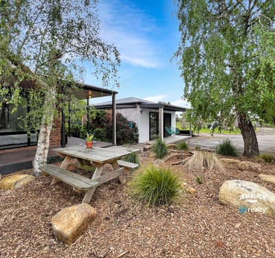 Discover a unique outdoor space featuring a picnic area surrounded by natural landscaping and modern amenities.