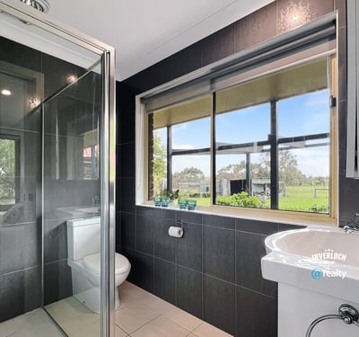 Bright bathroom featuring modern fixtures and scenic views, perfect for relaxation and comfort.