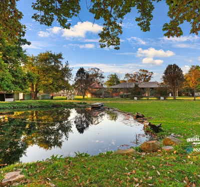 Discover a picturesque waterfront property surrounded by lush greenery and ample outdoor space for relaxation.