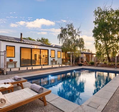 This modern home features a private pool and spacious outdoor area, perfect for entertaining and relaxation.